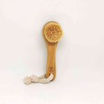 Soft Detox & Glow Face Brush featuring a bamboo handle, soft goat bristles, and a braided rope for easy hanging.
