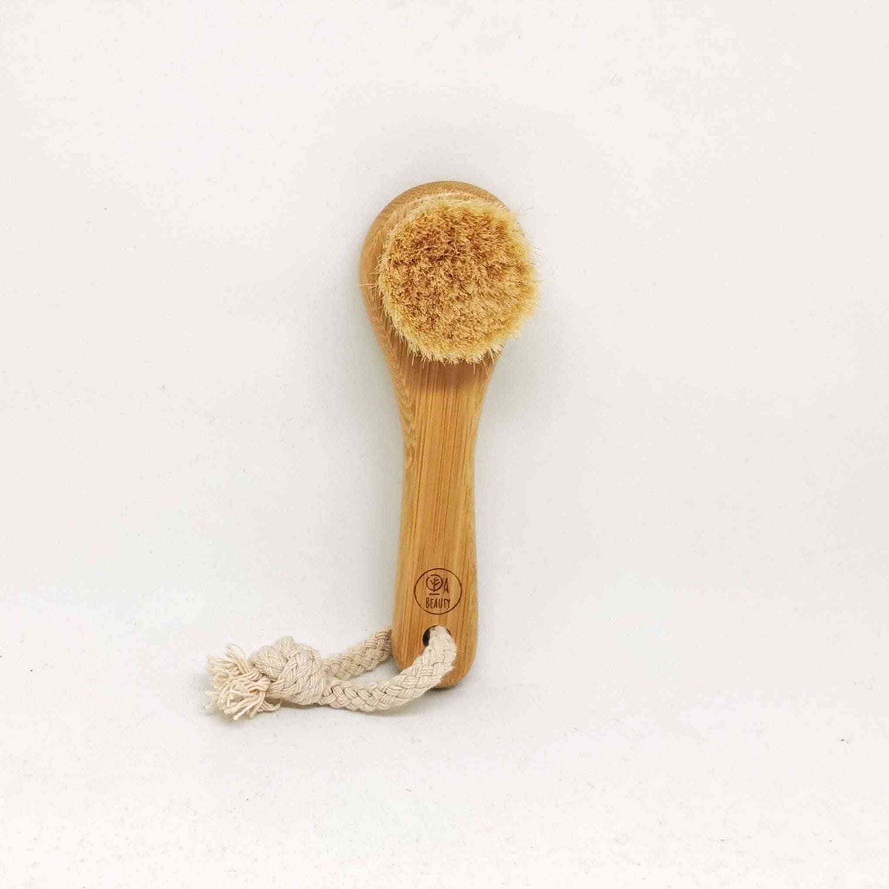 Soft Detox & Glow Face Brush featuring a bamboo handle, soft goat bristles, and a braided rope for easy hanging.